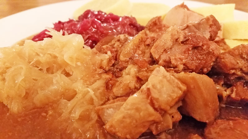 czech pork meal called moravsky vrabec with red and white sweet cabbage