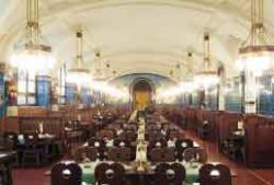 the cellar styled plzenska czech restaurant in prague with centre seating and side booths lit by hanging chandeliers