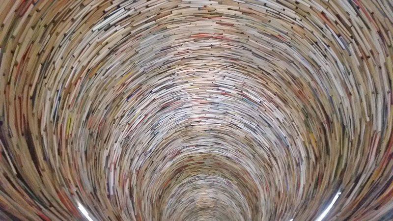 idiom, prague book tunnel looking into a cylinder lined with books