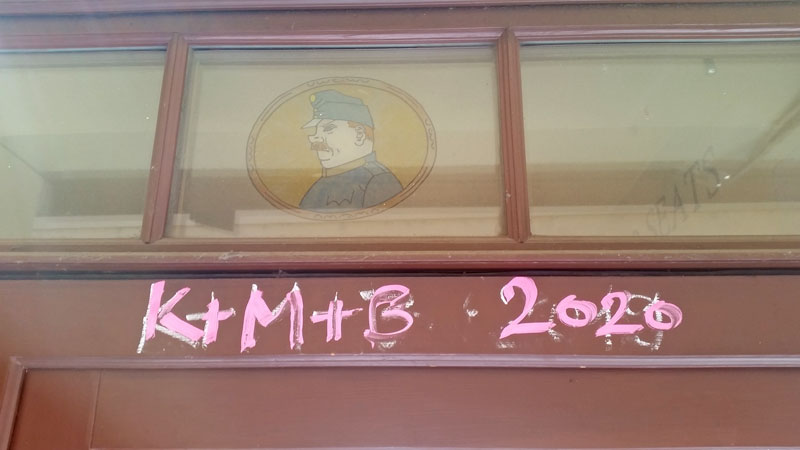 K+M+B 2020 three kings blessing written in liquid pink chalk on a door frame in prague