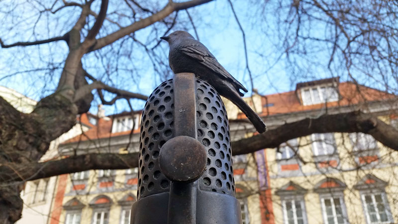 Milada Horakova memorial in prague bird perched on microphone