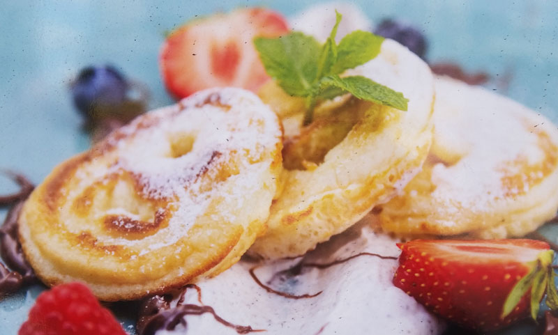 czech livanec pancakes on cream with strawberries, raspberries and bluberries