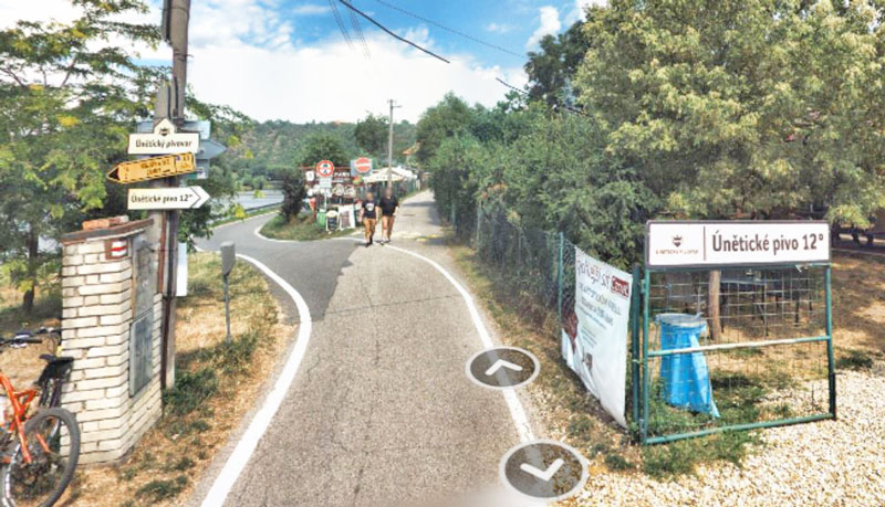 two grill restaurants on the prague a2 bike trail with signs showing uneticke 12 degree beer