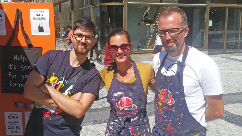 two men and a woman with paint splattered aprons