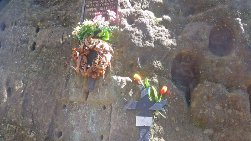 plaques on a rock face showing where people died