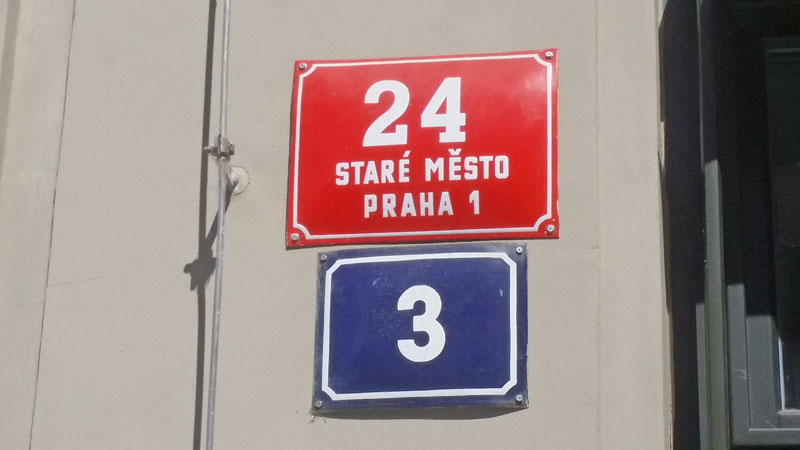 Building numbers in prague on red and blue plates