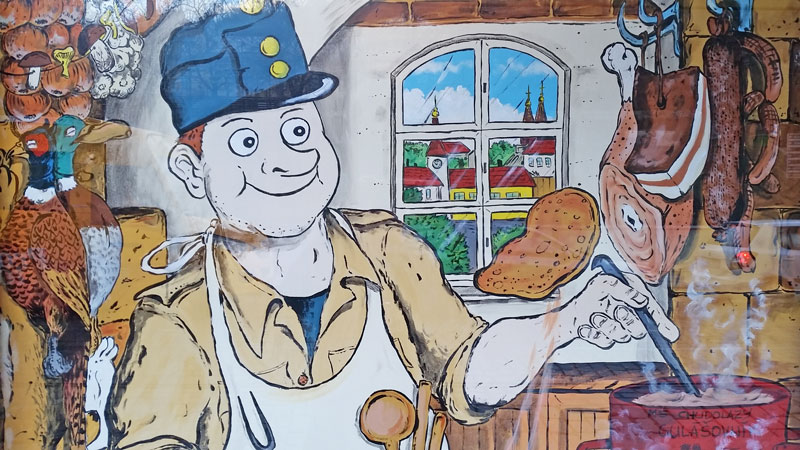 cartoon character of the good soldier svejk in a czech kitchen