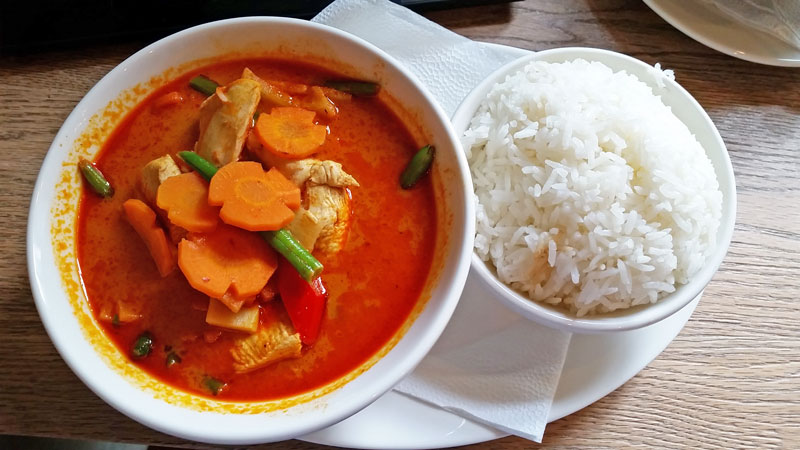 thai red chicken curry with separate bowl of rice