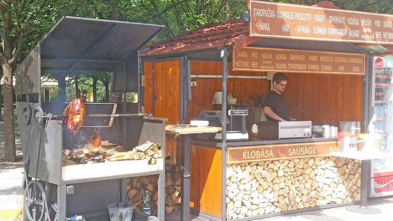 Old Prague Ham cooking next to a takeaway booth on the old town square