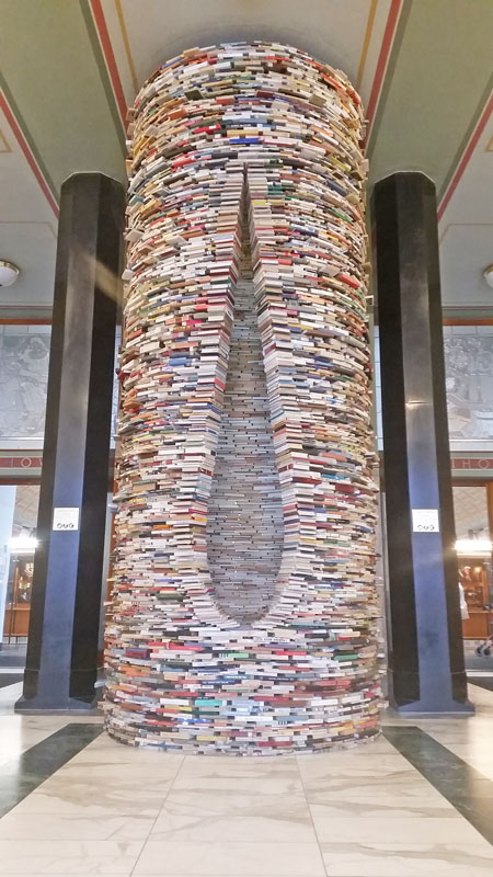 8000 books stacked into a cylinder and teardrop hole