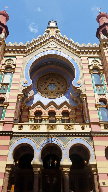 portrait view of the moorish revival jubilee synagogue in prague with it's red green and blue facade