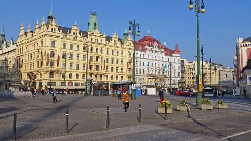 scene view of republic square in prague. cobble stone square with planted pots and art deco style street lamps