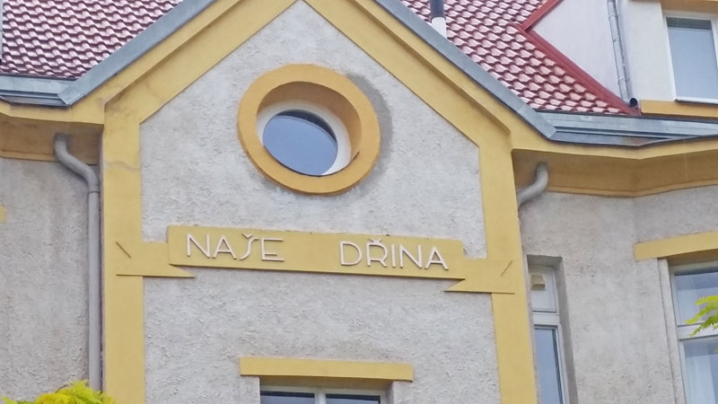 czech building with a sign saying nase drina which means our drudgery