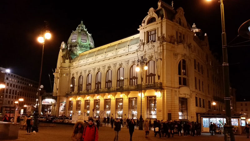 prague municipal house at night bathed in orange light