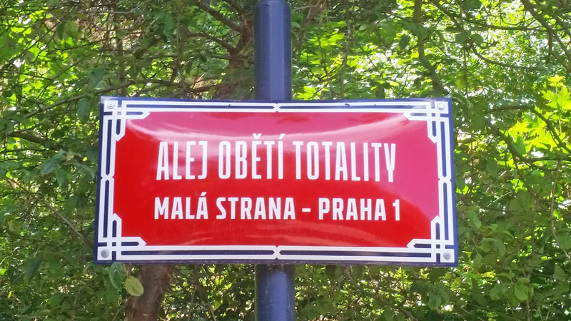 a street sign in czech which translates as the alley to the victims of totalitarianism