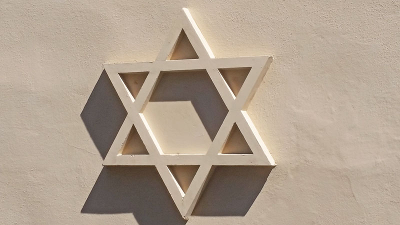 star of david casting a shadow on a wall