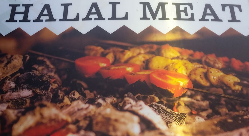 sign saying halal meat over a turkish grill prague halal food