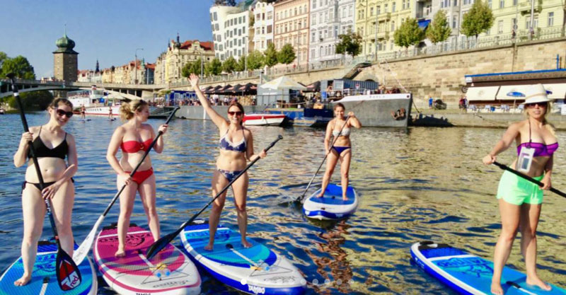 five girls prague paddleboarding on the river vltava