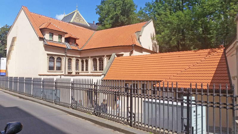 two offset renaissance style buildings with red tiled roofs called pinkas synagogue