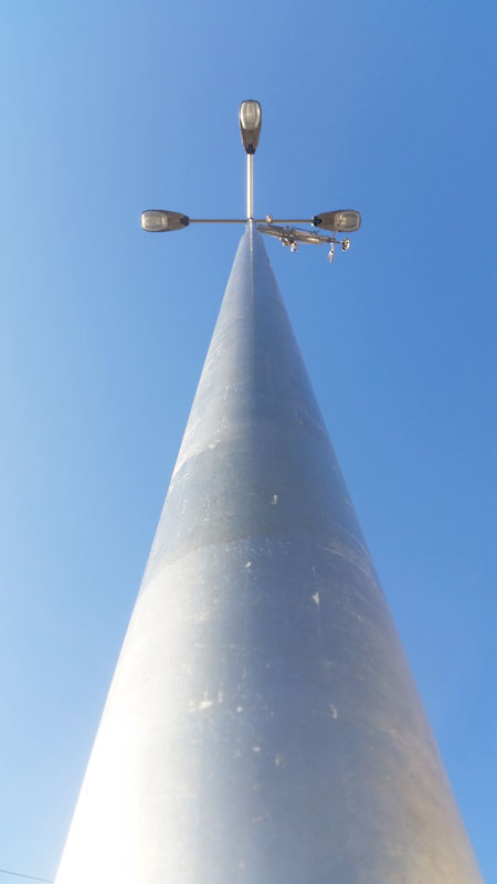 view from the base of a silvered street light lamp post looking up