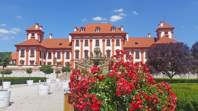 17th century baroque style troja chateau with roses in foreground