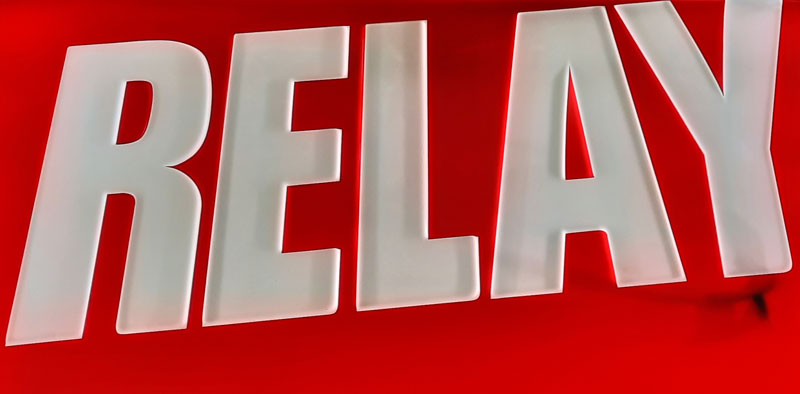 the word relay on a red background is the sign of a trafika or tabak in prague