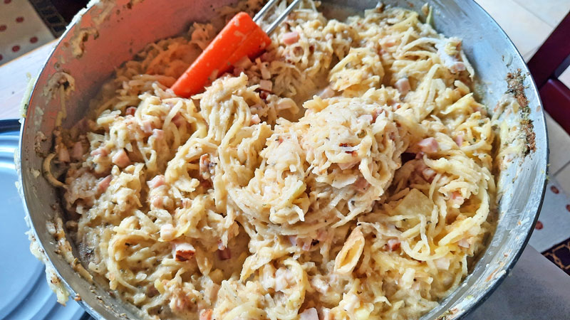 Mixing Bramborak ingredients in a bowl