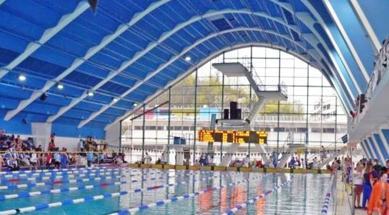 Internal view of the Prague Podoli Swimming Pool with marked lanes and diving decks