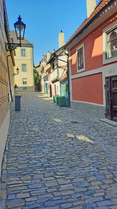 prague castle golden lane with houses on the right looking back to the entry on the left