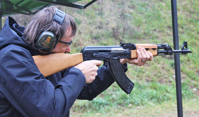 man shooting in prague with ear protectors firing a kalashnikov ak47
