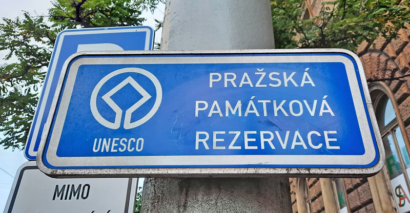 city street sign saying that you are entering the prague monument reserve and the prague unesco world heritage list area