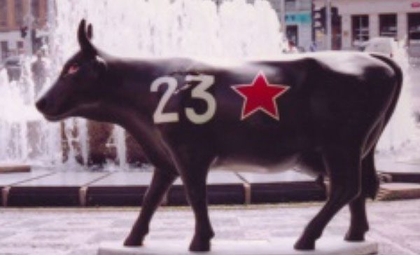 cow parade black cow with number 23 and red army star