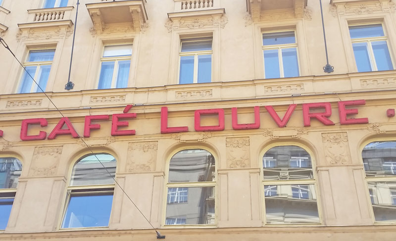 facade of a building showing the name cafe louvre