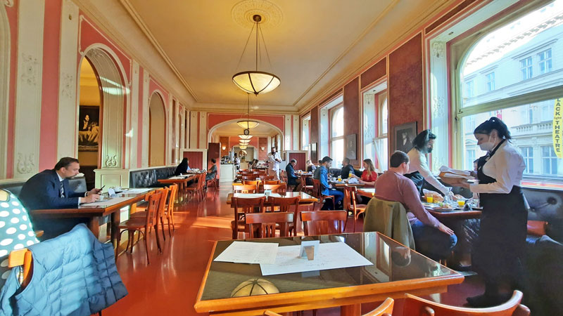 prague cafe louvre interior with customers and waitresses serving tables