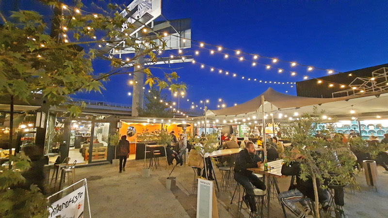 people eating and drinking at manifesto market florenc outdoor eating in prague