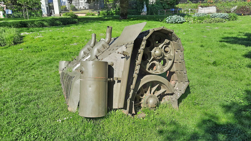 piece of a tank embedded in the ground in prague by david cerny