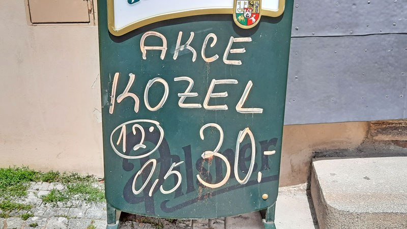 a chalk board sign with a discount on kozel czech beer