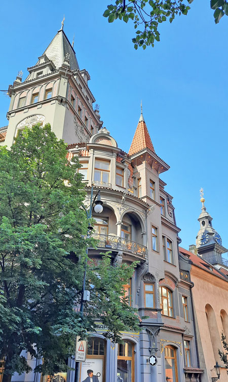 an avant-garde building in prague paris street with renaissance arcade and gothic tower