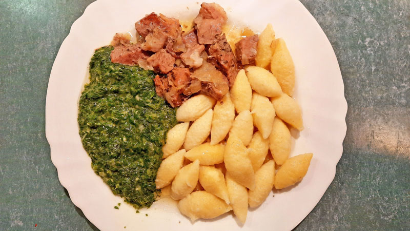 czech food kruti served with spinach and potato gnocchi