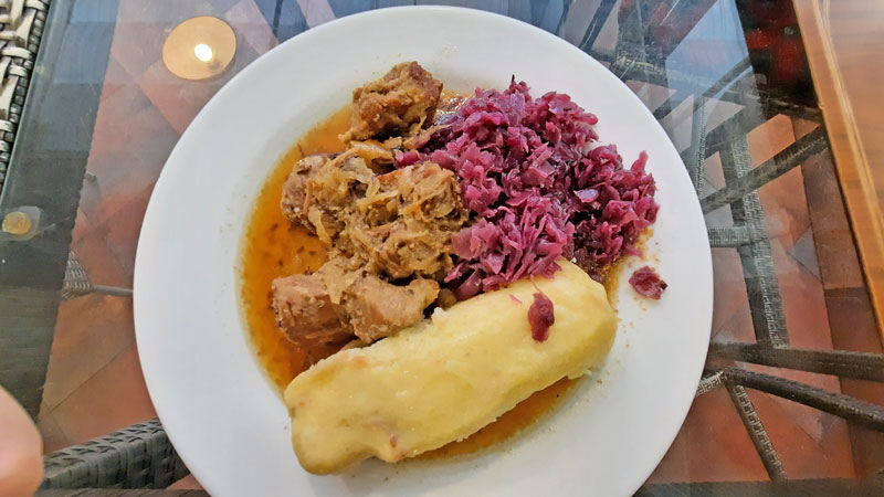 czech food moravsky vrabec with big potato dumpling and red cabbage