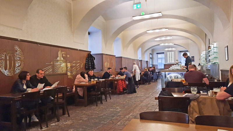 lokal beerhall in prague dlouha street with people drinking at tables