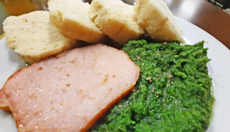 czech meal called uzena which is a slice of smoked pork with pureed spinach and dumplings