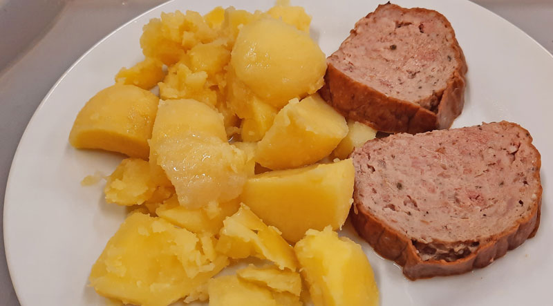 two slices of meatloaf or what czechs call sekana with boiled potatoes