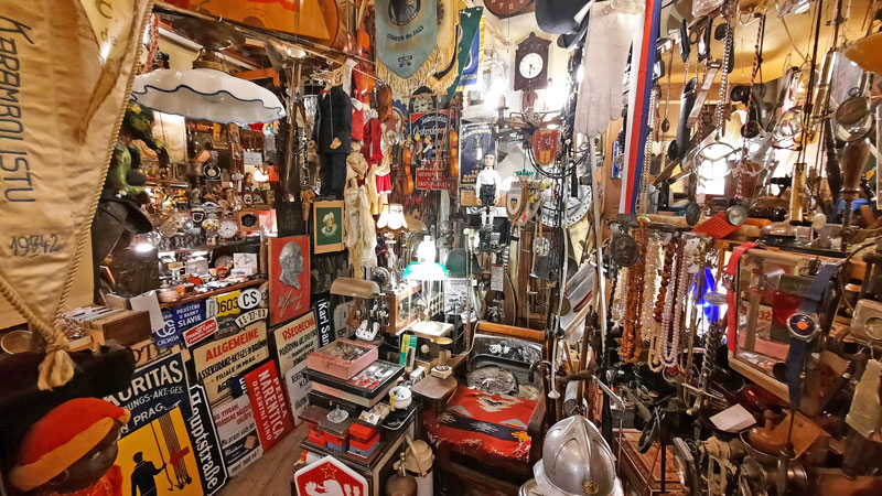 the interior of a shop in prague called bric a brac showing all kinds of antique and flea market goods including czech memorabilia