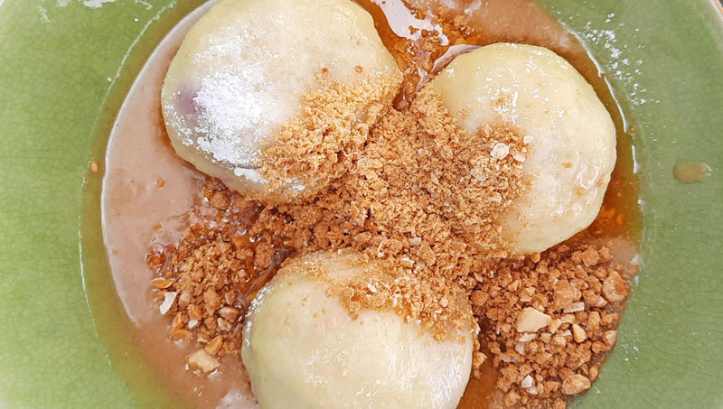 three traditional czech plum dumplings with sugar and grated gingerbread
