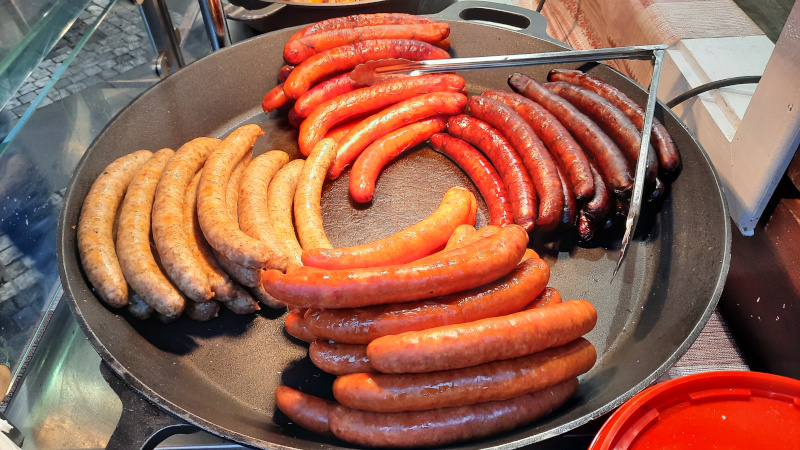 different types of hot dogs in a pan