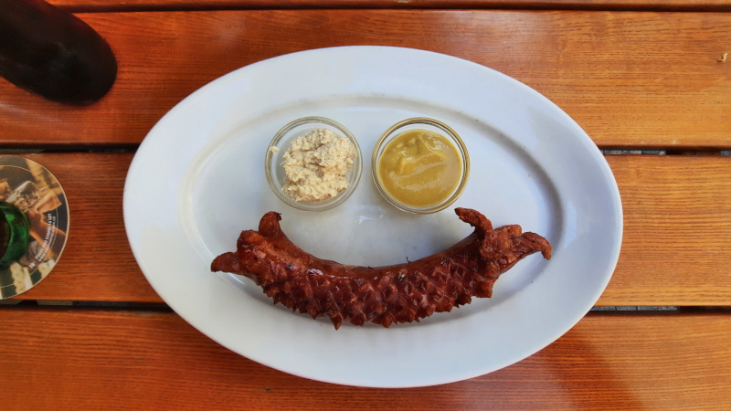 prague klobasa hot dog arranged on a plate in the shape of a smile