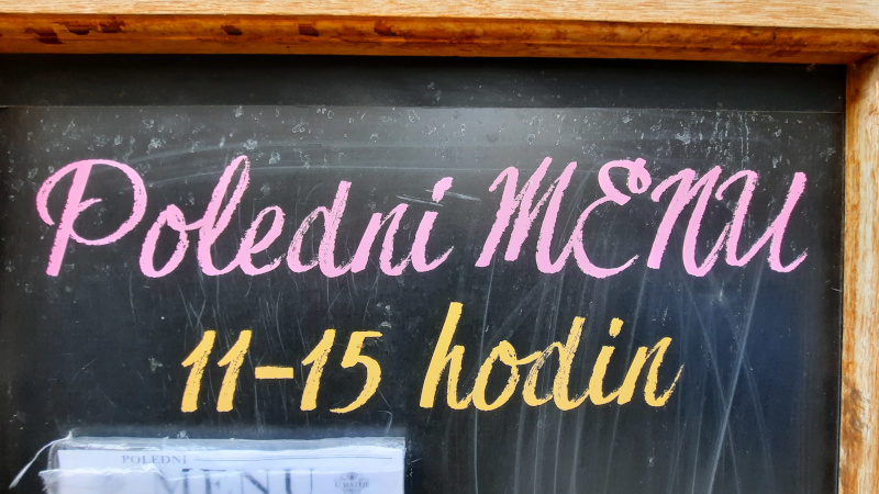 czech sign saying poledni menu which means the czech lunch menu being served between 11am and 3pm