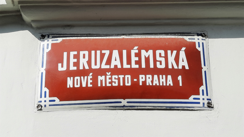 street sign in Prague that says jeruzalemska in white text on a red background