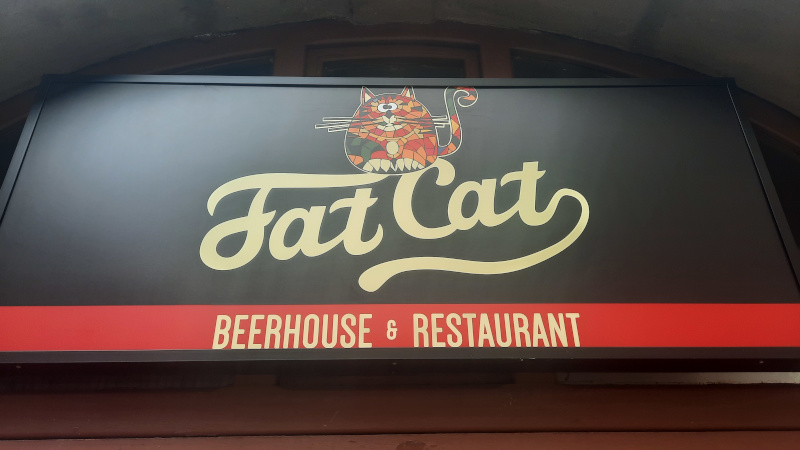 signage of fat cat restaurant in prague